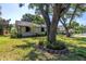 Well-kept lawn and mature trees surround the property, enhancing its natural beauty and curb appeal at 7461 Pescador Pl, Seminole, FL 33772