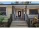 Inviting front porch with stone accents and stylish black trim at 7461 Pescador Pl, Seminole, FL 33772
