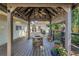Charming gazebo with a ceiling fan and cozy lighting, perfect for outdoor gatherings at 7461 Pescador Pl, Seminole, FL 33772