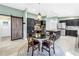 Spacious kitchen with black cabinets, stainless steel appliances, and an adjacent dining area at 7461 Pescador Pl, Seminole, FL 33772