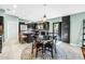 Bright kitchen featuring stainless appliances, black cabinets, large island and dining space with patio access at 7461 Pescador Pl, Seminole, FL 33772