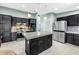 Modern kitchen featuring black cabinetry, stainless steel appliances, and granite countertops at 7461 Pescador Pl, Seminole, FL 33772