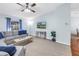 Comfortable living room boasts a gray sectional sofa, soft carpet, and modern decor at 7461 Pescador Pl, Seminole, FL 33772