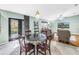 Well-lit living space with a round dining table and comfortable seating area at 7461 Pescador Pl, Seminole, FL 33772