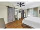 Stylish bedroom features a sliding barn door, closet, and modern finishes at 7461 Pescador Pl, Seminole, FL 33772