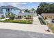 Overhead shot of home with manicured landscaping, complemented by the driveway and neighborhood at 807 Illinois Ave, Palm Harbor, FL 34683