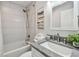 Bathroom featuring granite countertops, shower/tub combination, and soft, neutral wall decor at 807 Illinois Ave, Palm Harbor, FL 34683