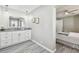 Bright bathroom featuring a gray granite countertop and undermount sink, complemented by gray wood-look flooring at 807 Illinois Ave, Palm Harbor, FL 34683
