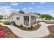 Quaint home showcasing a screened front porch, attractive landscaping, and a brick-lined walkway at 807 Illinois Ave, Palm Harbor, FL 34683