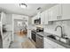 Updated kitchen featuring granite countertops, stainless appliances, subway tile backsplash, and white cabinets at 807 Illinois Ave, Palm Harbor, FL 34683