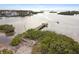 Scenic waterfront view with a wooden dock extending into the bay, perfect for boating and enjoying the water at 807 Illinois Ave, Palm Harbor, FL 34683