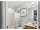 Well-lit bathroom with a shower-tub combination, framed mirror, and neutral color palette at 8415 Edgewater Place Blvd, Tampa, FL 33615