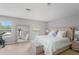 Bright bedroom featuring neutral tones, carpet flooring, and exercise equipment at 8415 Edgewater Place Blvd, Tampa, FL 33615