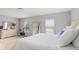 Bright bedroom showcasing large windows, blinds, and an exercise bike at 8415 Edgewater Place Blvd, Tampa, FL 33615