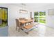 Dining area with modern light fixture, dining table and bench with a pond view at 8415 Edgewater Place Blvd, Tampa, FL 33615