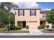 Charming townhome with a well-manicured lawn, black shutters and a one car garage at 8415 Edgewater Place Blvd, Tampa, FL 33615
