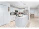 Modern kitchen featuring white cabinets, stainless steel appliances, and an island at 8415 Edgewater Place Blvd, Tampa, FL 33615