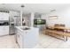 Bright kitchen with an island sink, a dining table, and an aquarium at 8415 Edgewater Place Blvd, Tampa, FL 33615