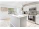 Well-lit kitchen with white cabinets, granite countertops, and stainless-steel appliances at 8415 Edgewater Place Blvd, Tampa, FL 33615