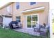 Cozy outdoor patio with comfortable seating, a grill, and a view of the backyard at 8415 Edgewater Place Blvd, Tampa, FL 33615