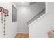 Staircase leading upstairs with a wooden handrail and decorative items on the wall at 8415 Edgewater Place Blvd, Tampa, FL 33615