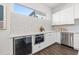 Contemporary kitchen with stainless steel appliances, white cabinetry, and ample counter space at 851 6Th S Ave, St Petersburg, FL 33701