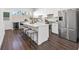 Modern kitchen boasts a spacious island with seating, stainless steel appliances, and sleek white cabinetry at 851 6Th S Ave, St Petersburg, FL 33701