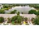 Aerial view of townhomes in a community with a serene lake and lush greenery at 8568 Sandy Beach St, Tampa, FL 33634