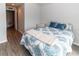 Cozy bedroom with comfortable bed and soft blue accents, and hardwood floors at 8568 Sandy Beach St, Tampa, FL 33634