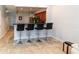 Open concept dining area featuring a breakfast bar with modern black stools at 8568 Sandy Beach St, Tampa, FL 33634