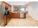 Spacious kitchen with stainless steel appliances and view into dining area at 8568 Sandy Beach St, Tampa, FL 33634