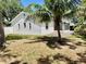 Backyard featuring screened in porch and lush, tropical landscaping at 9191 64Th N Way, Pinellas Park, FL 33782