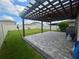 Inviting backyard patio with pergola, paver stones and a grill, perfect for entertaining at 9520 Lemon Drop Loop, Sun City Center, FL 33573