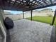 A backyard with a lovely paved patio area featuring a pergola and outdoor lighting at 9520 Lemon Drop Loop, Sun City Center, FL 33573