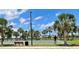 Community basketball court with palm trees and a view of the lake at 9520 Lemon Drop Loop, Sun City Center, FL 33573