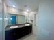 Bathroom with double sink vanity and a large mirror at 9520 Lemon Drop Loop, Sun City Center, FL 33573