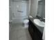 Well-lit bathroom featuring a granite vanity, a modern sink, and a shower-tub combo at 9520 Lemon Drop Loop, Sun City Center, FL 33573