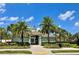 Beautiful community entrance with palm trees and manicured landscaping at 9520 Lemon Drop Loop, Sun City Center, FL 33573