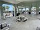 Open-air community pavilion with picnic tables, ceiling fans and a view of the community pool at 9520 Lemon Drop Loop, Sun City Center, FL 33573