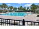 Large community pool with lounge chairs and tropical landscaping, perfect for relaxation and recreation at 9520 Lemon Drop Loop, Sun City Center, FL 33573