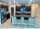 Modern kitchen featuring stainless steel appliances, dark wood cabinetry, and a granite island at 9520 Lemon Drop Loop, Sun City Center, FL 33573