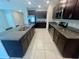 Stylish kitchen featuring granite countertops, stainless steel appliances, and dark wood cabinets at 9520 Lemon Drop Loop, Sun City Center, FL 33573