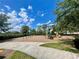Community playground featuring swings, slides, and climbing structures, set against a backdrop of blue skies and lush greenery at 9520 Lemon Drop Loop, Sun City Center, FL 33573