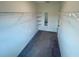 Spacious walk-in closet with custom shelving, carpet flooring, and a mirror at 9520 Lemon Drop Loop, Sun City Center, FL 33573