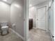 Bathroom with granite vanity, tile floor, glass shower, and a white toilet at 9605 Channing Hill Dr, Sun City Center, FL 33573