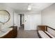 Bedroom with a crib, dresser, round mirror, and neutral decor at 9605 Channing Hill Dr, Sun City Center, FL 33573