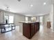 An island kitchen with wooden cabinets, granite countertops and stainless steel appliances at 9605 Channing Hill Dr, Sun City Center, FL 33573