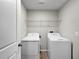 Functional laundry room with washer, dryer, and overhead shelf, providing convenience and organization at 9605 Channing Hill Dr, Sun City Center, FL 33573