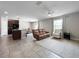 Open-concept living space with tile flooring, a ceiling fan, and a mix of seating arrangements at 9605 Channing Hill Dr, Sun City Center, FL 33573