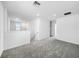Bright loft area with neutral gray carpet, white walls, and natural light from the window at 9605 Channing Hill Dr, Sun City Center, FL 33573
